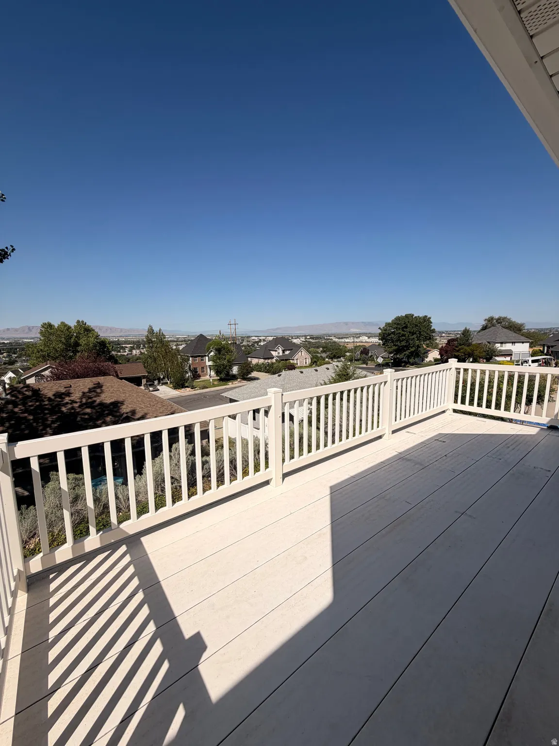 Expansive outdoor deck featuring composite decking and a white railing system