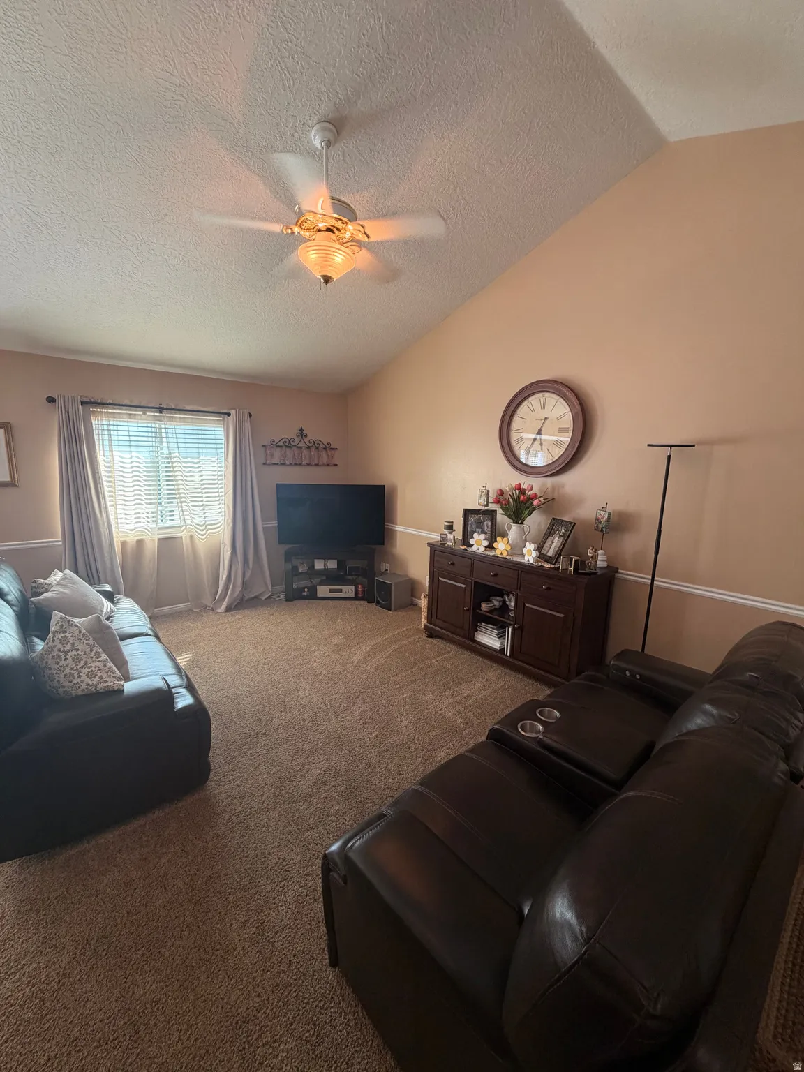 Vaulted ceiling with an illuminated ceiling fan