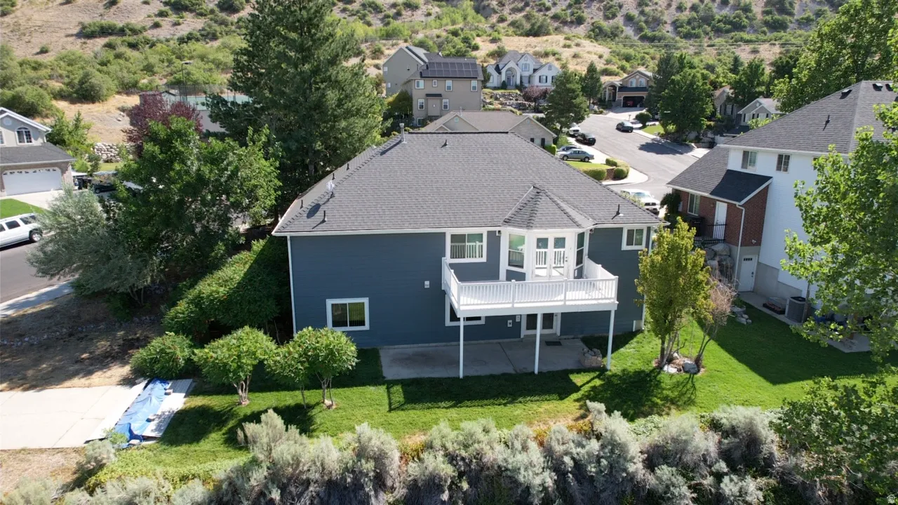 Modern residence featuring a dark gray roof, blue siding, and white trim