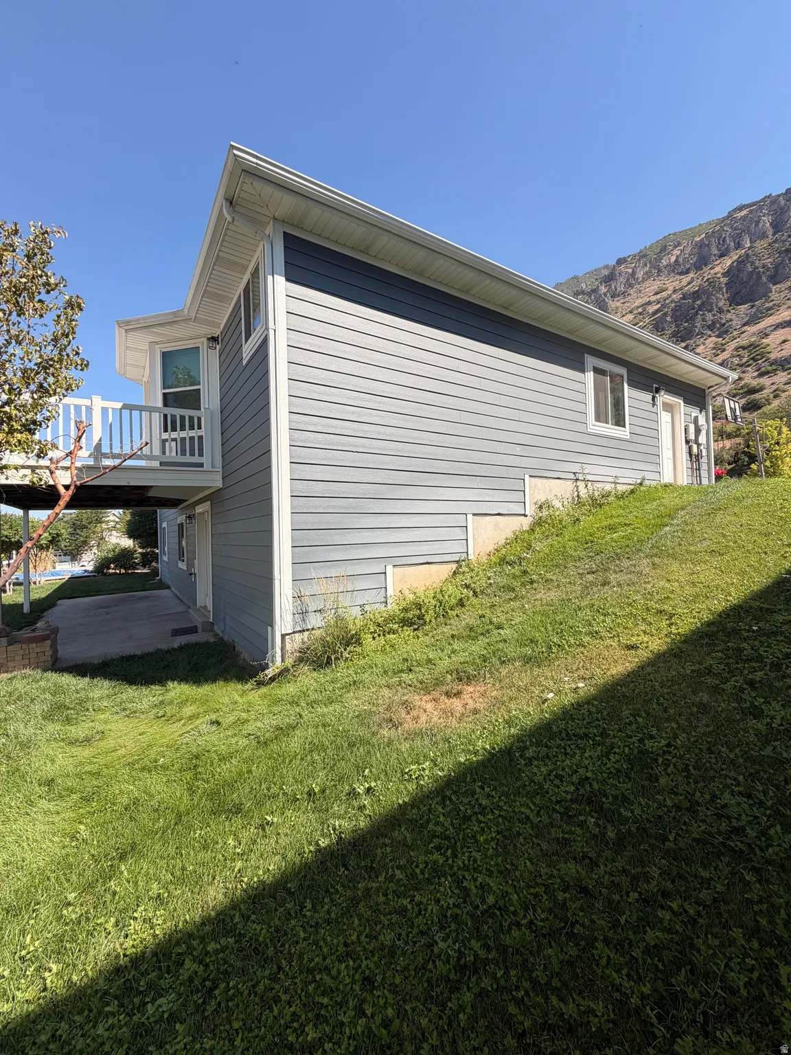 Contemporary residence featuring light blue siding with white trim