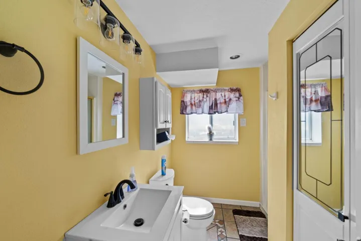 White vanity with an integrated sink and black faucet