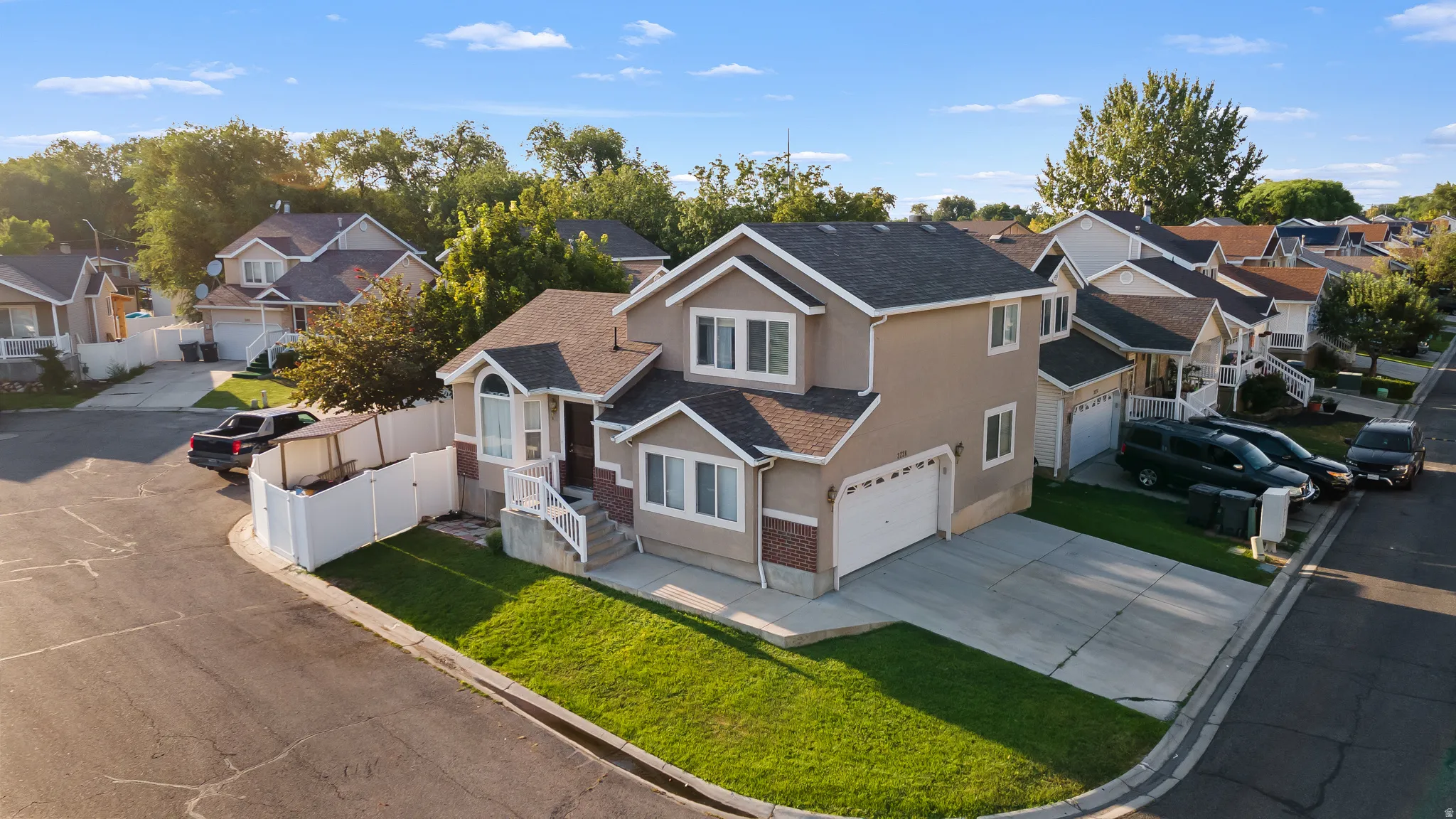 Two-story residence featuring a stucco exterior, attached two-car garage, and a corner lot