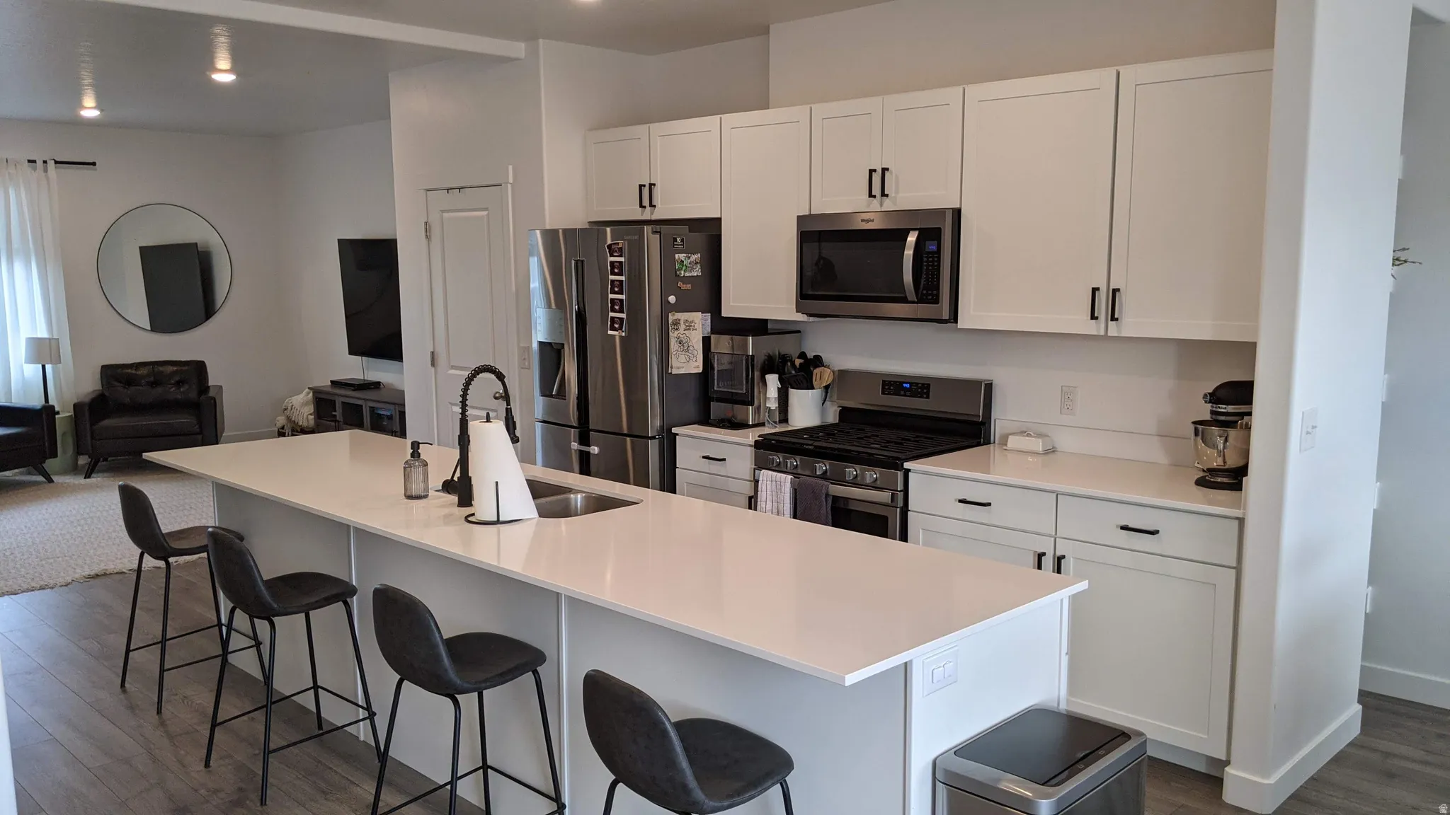 Kitchen featuring an expansive island with an undermount sink and gooseneck faucet