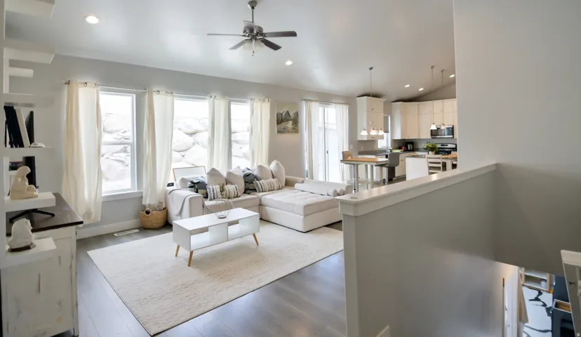 Open-concept living space featuring wood-finish flooring, recessed lighting, and a ceiling fan