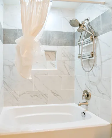 White acrylic bathtub with brushed nickel fixtures