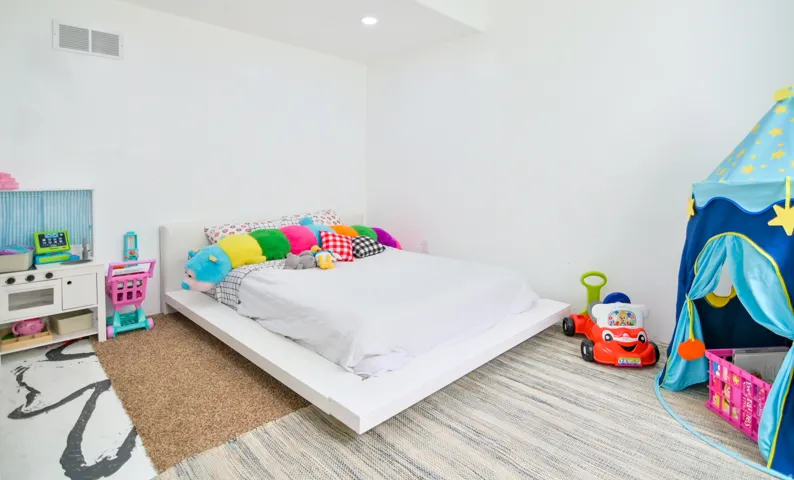 Bright room featuring white walls and a recessed ceiling light