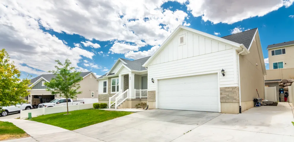 White siding exterior with a two-car garage