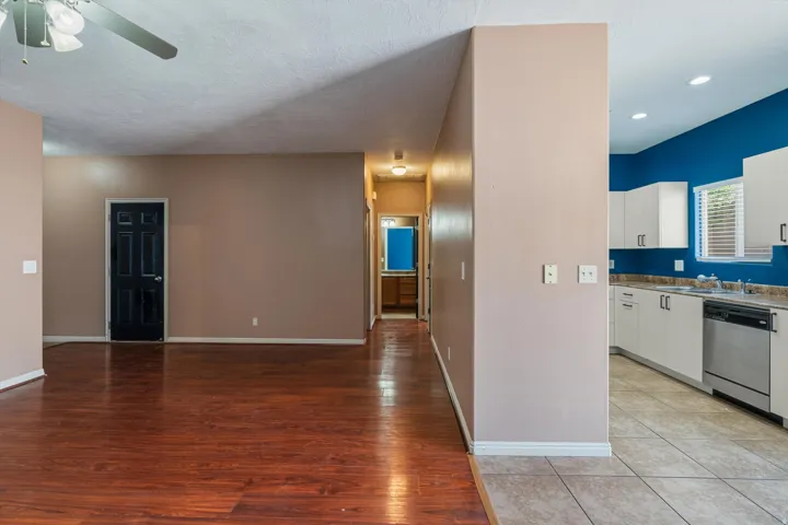 Spacious room featuring wood-finish flooring and a ceiling fan