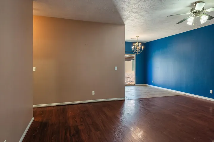 Interior space featuring rich wood-finish flooring and a contrasting tile floor