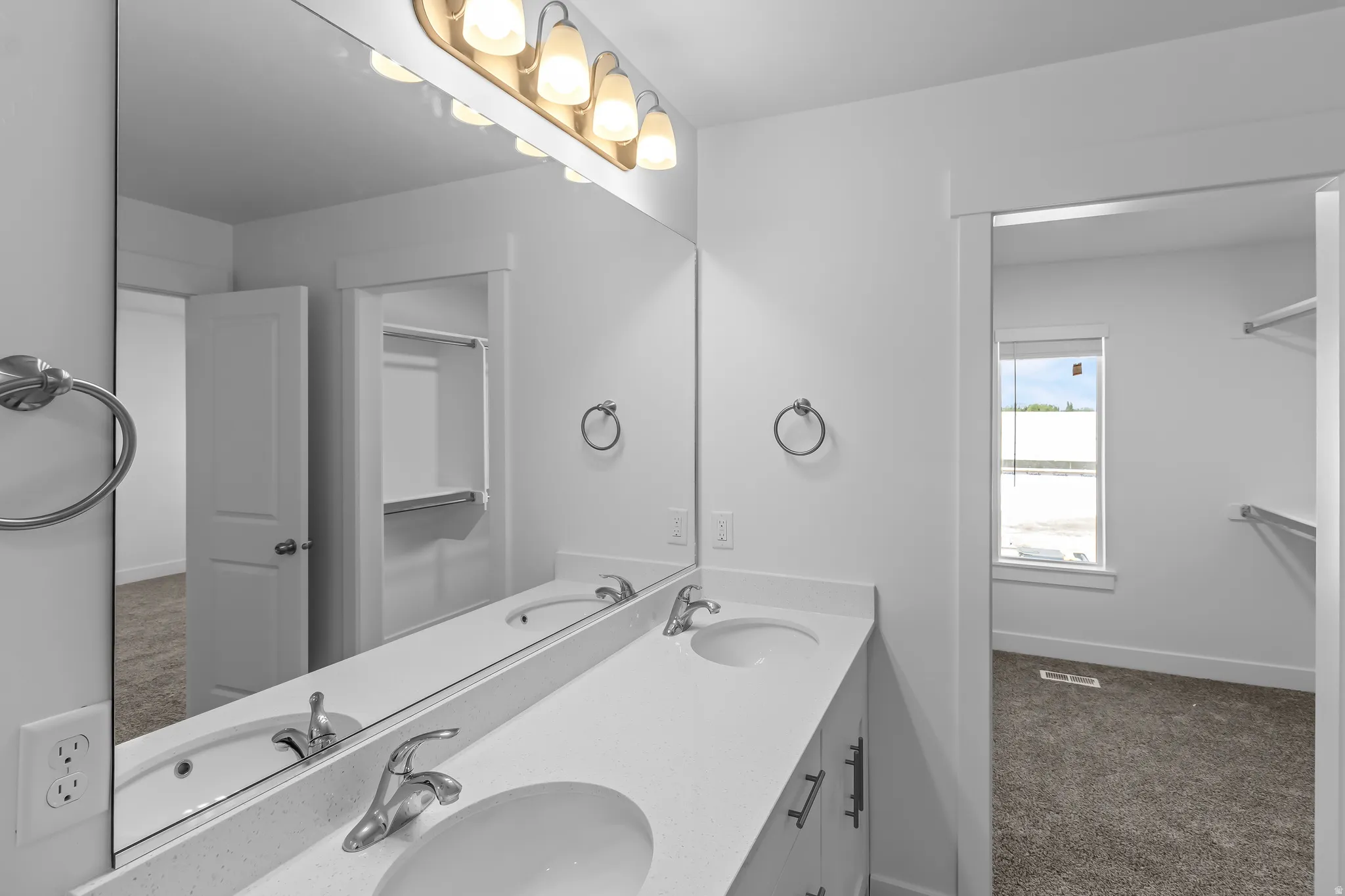 Dual vanity with integrated sinks and a light-toned countertop