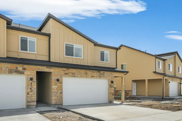 Modern townhome-style residences featuring stone veneer and siding exteriors