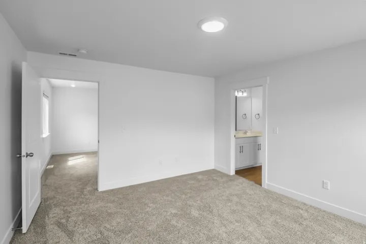 Plush carpeting throughout, with bright white walls and trim