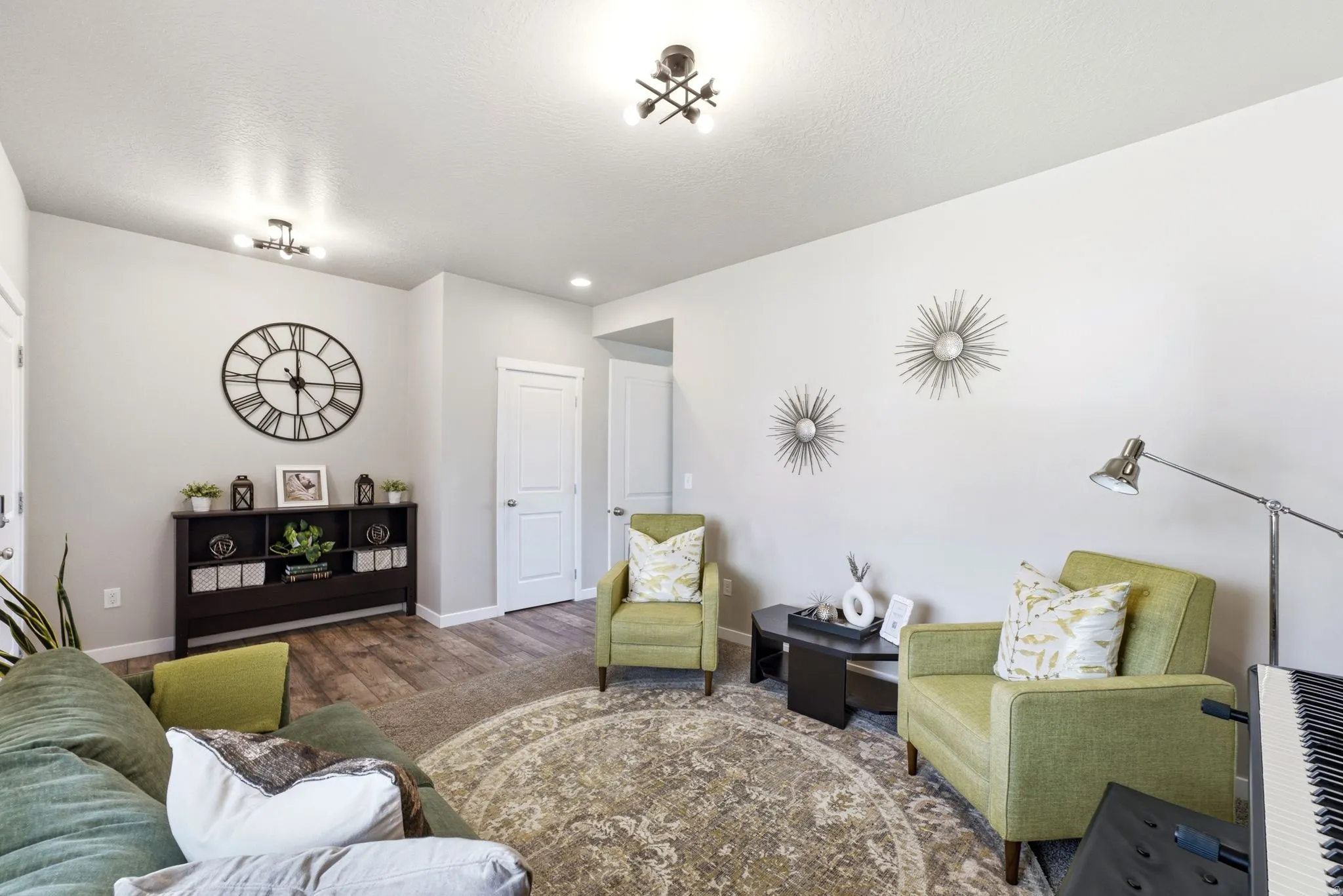 Interior space featuring wood-finish flooring, light-colored walls, and a decorative area rug