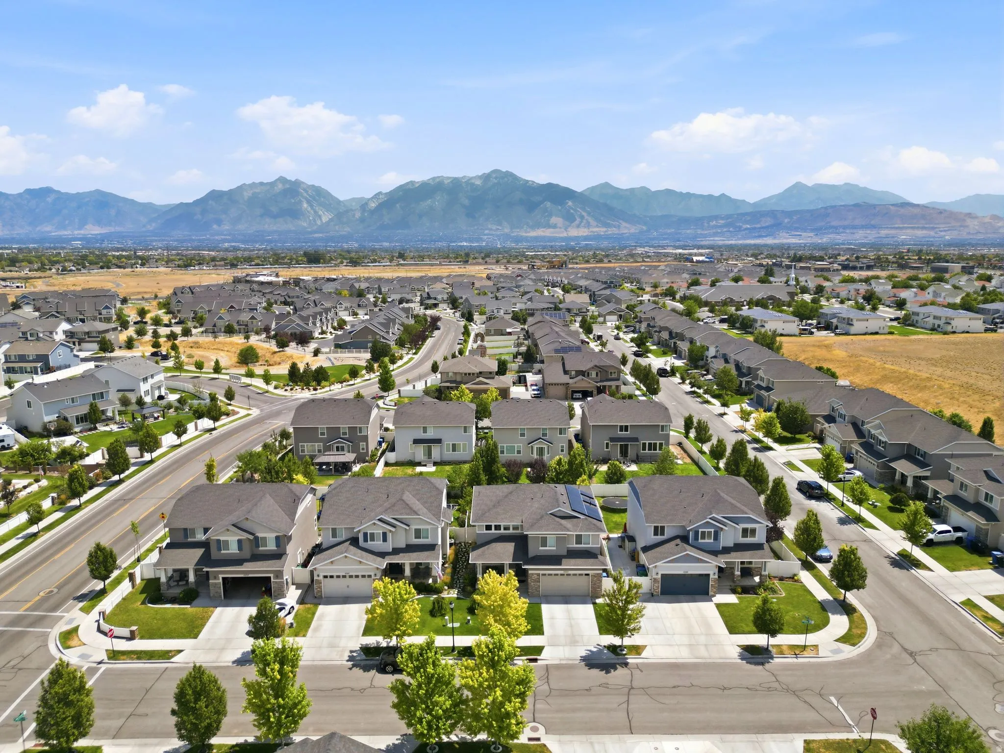 Expansive residential development featuring a diverse collection of single-family homes with mountain scenery backdrop