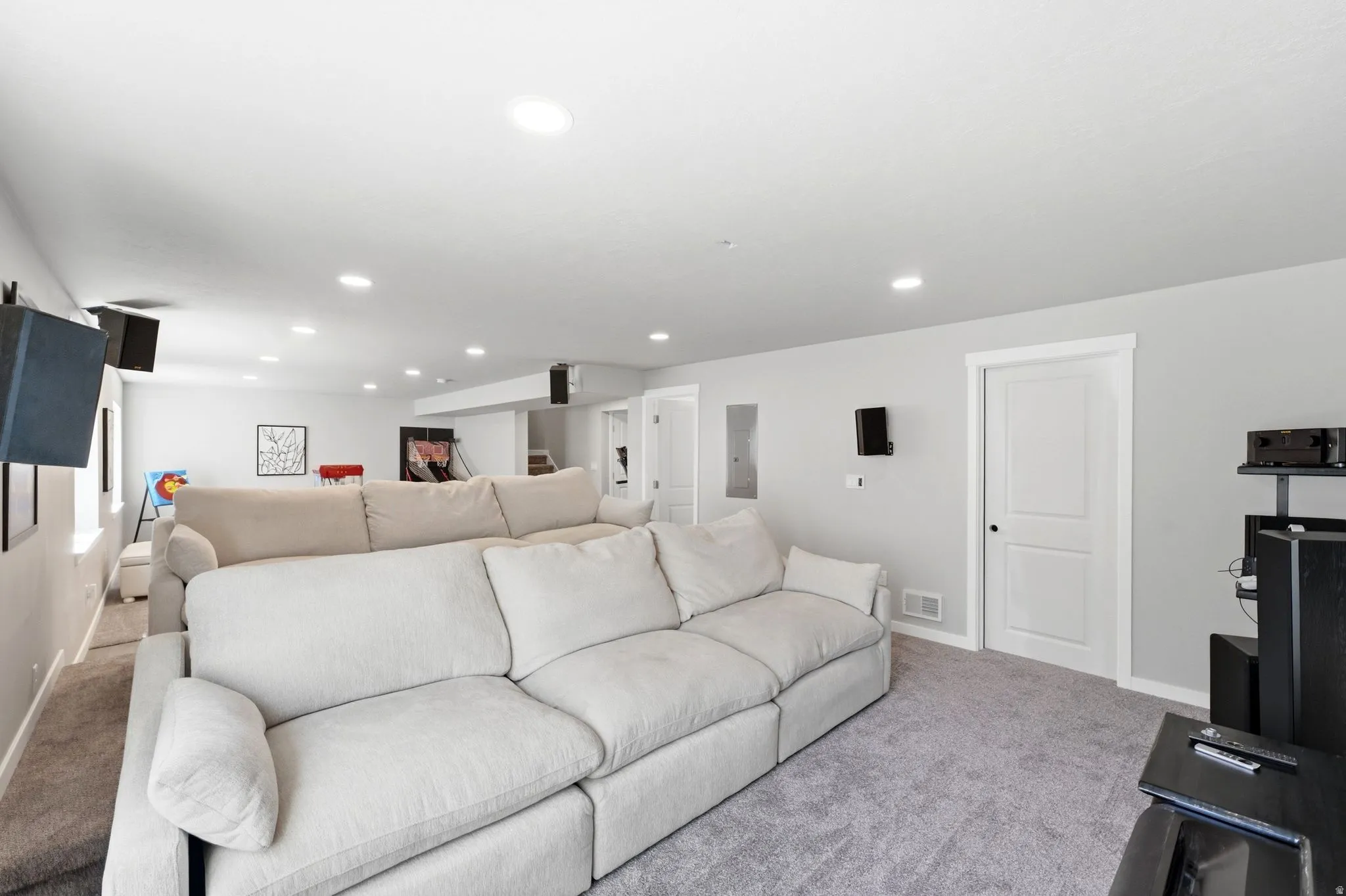 Finished lower level featuring recessed lighting, light gray walls, and gray carpeting throughout