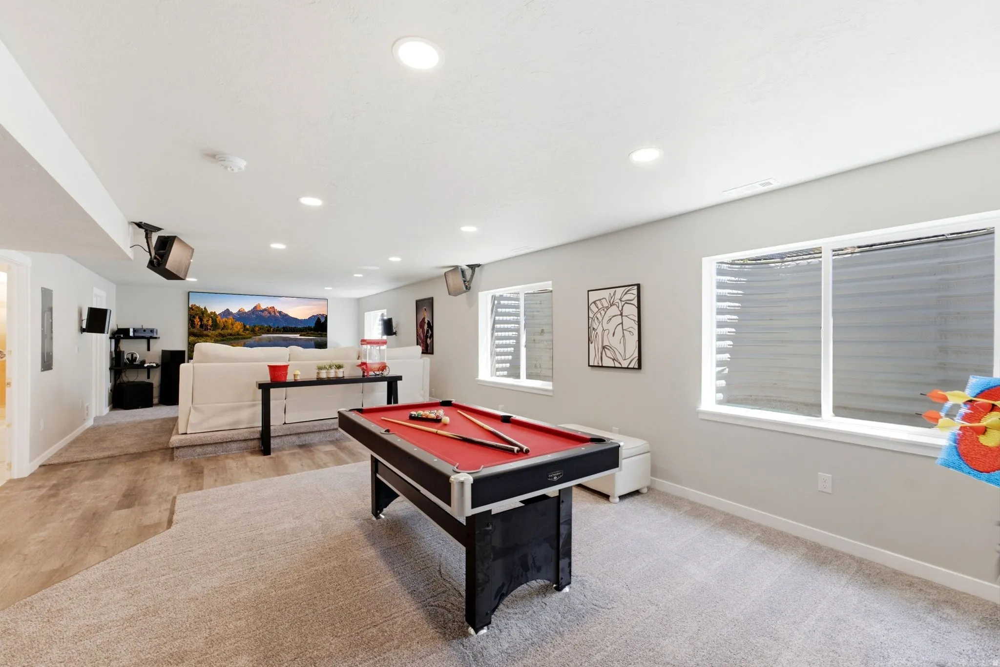 Spacious recreation area featuring recessed lighting and multiple windows