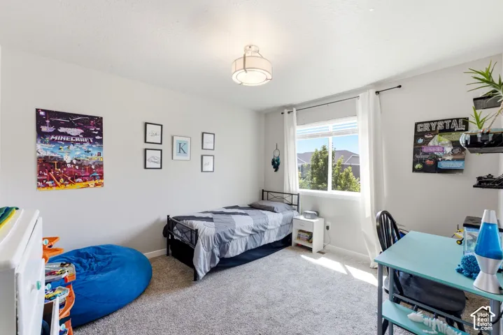 Recessed lighting fixture, light gray wall tones, window with white trim, and soft carpeting