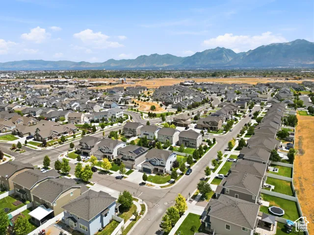 Expansive residential development featuring numerous single-family homes, paved streets, and well-maintained green spaces