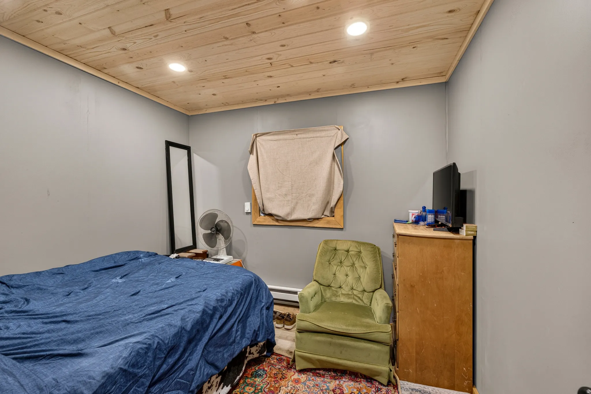 Room featuring a natural wood-finish ceiling, recessed lighting, and light gray painted walls