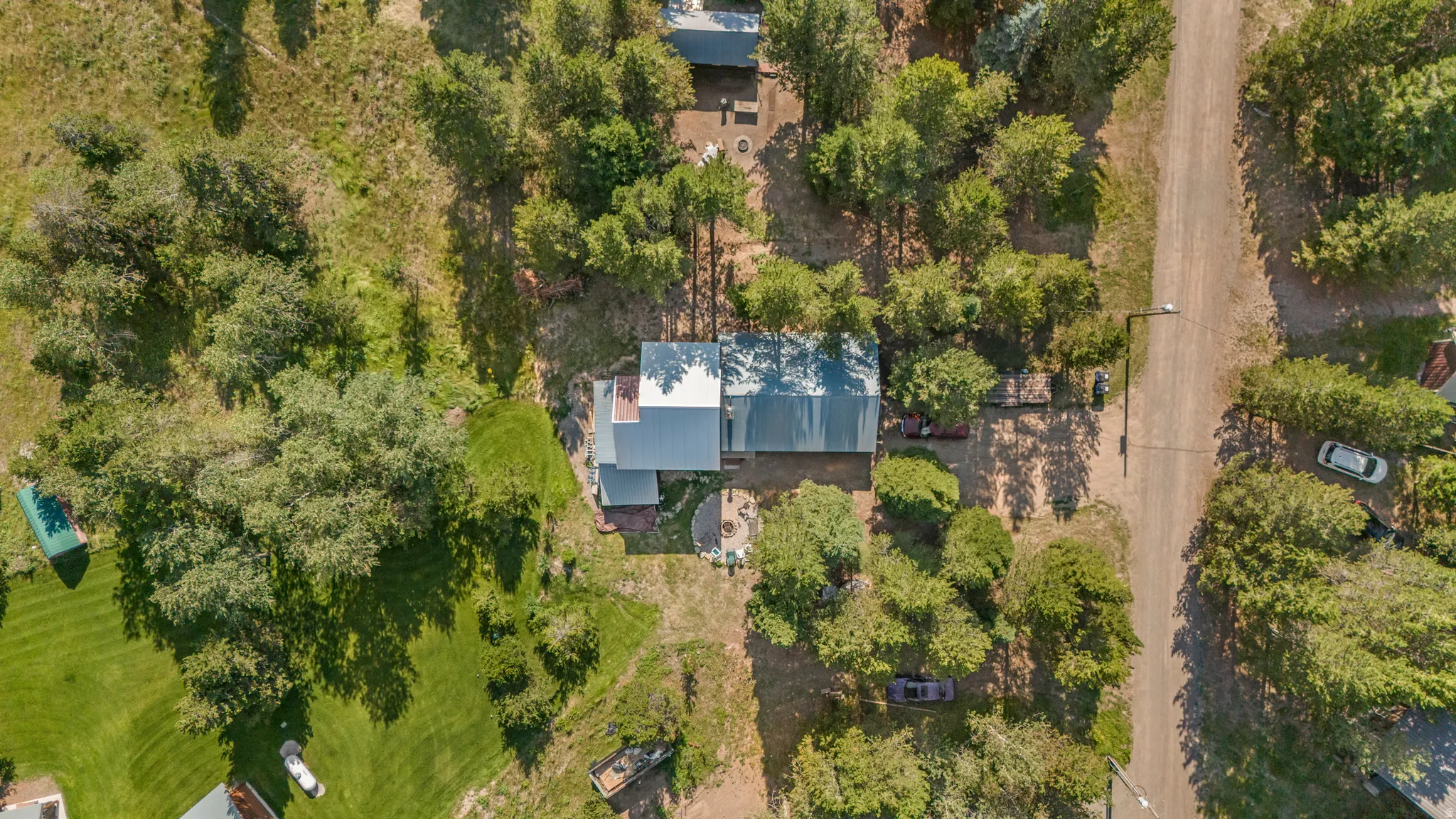 Overhead property view featuring a residence with a light-colored metal roof