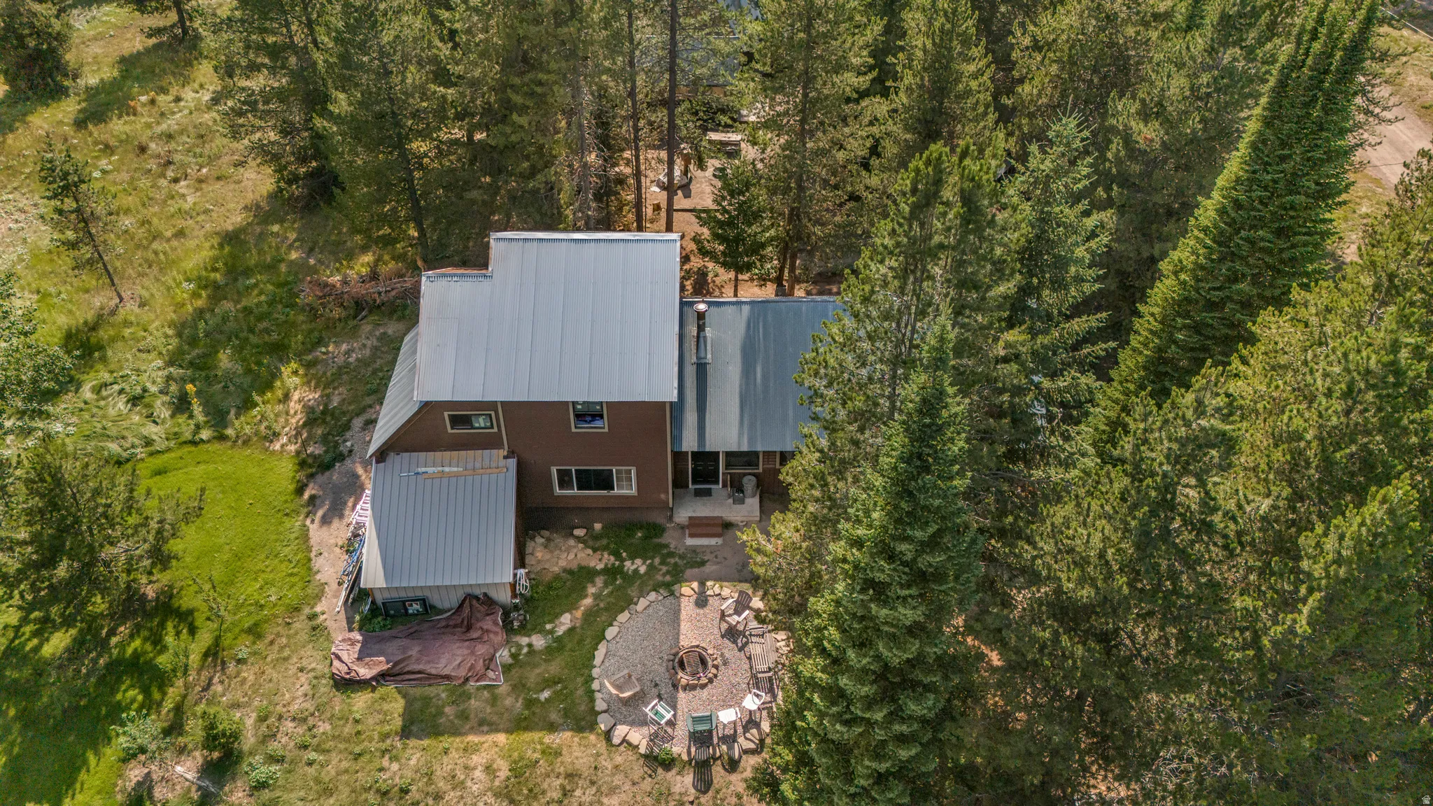 Brown-sided residence featuring a metal roof