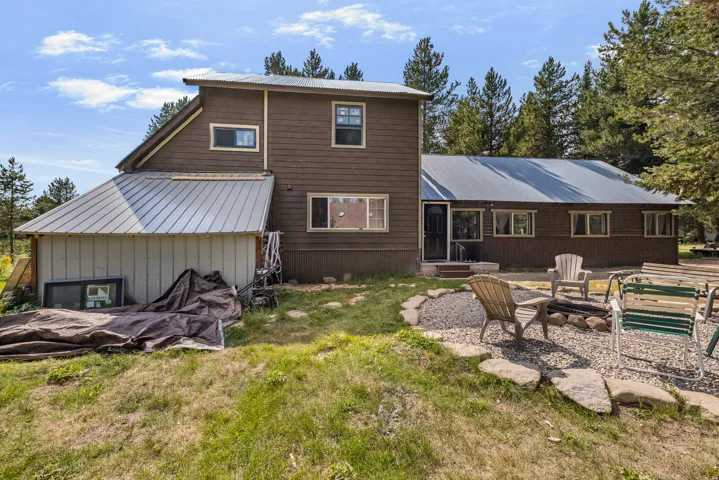 Brown siding exterior with multiple windows and a gray metal roof