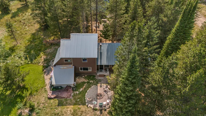 Brown-sided residence featuring a metal roof