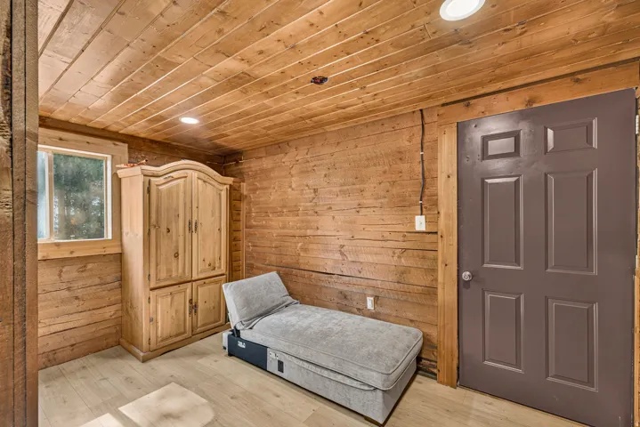 Paneled wood walls and ceiling with recessed lighting