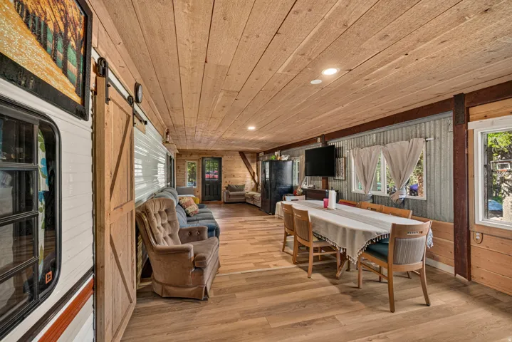 Open concept space featuring wood-finish flooring, recessed lighting, and a wood-plank ceiling