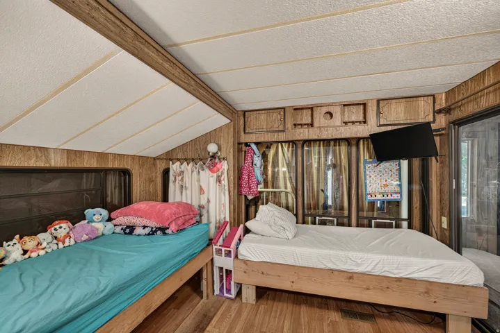 Interior space featuring wood-finish wall paneling and a paneled ceiling