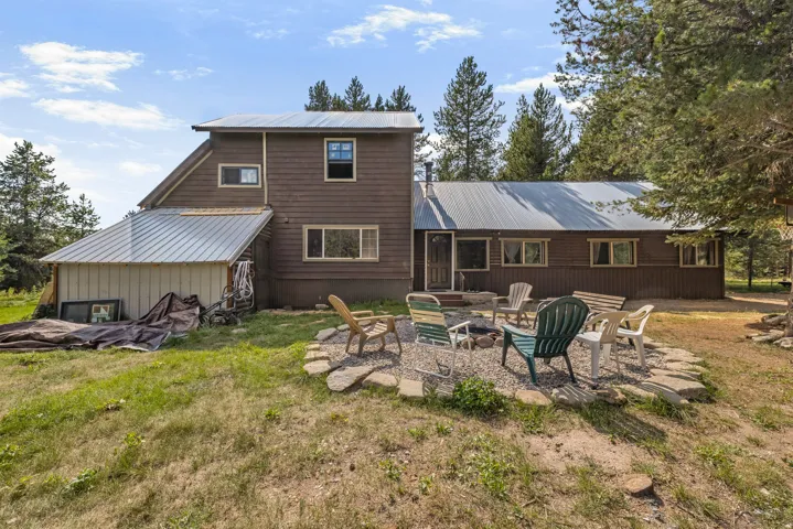 Rear exterior with brown siding and multiple windows