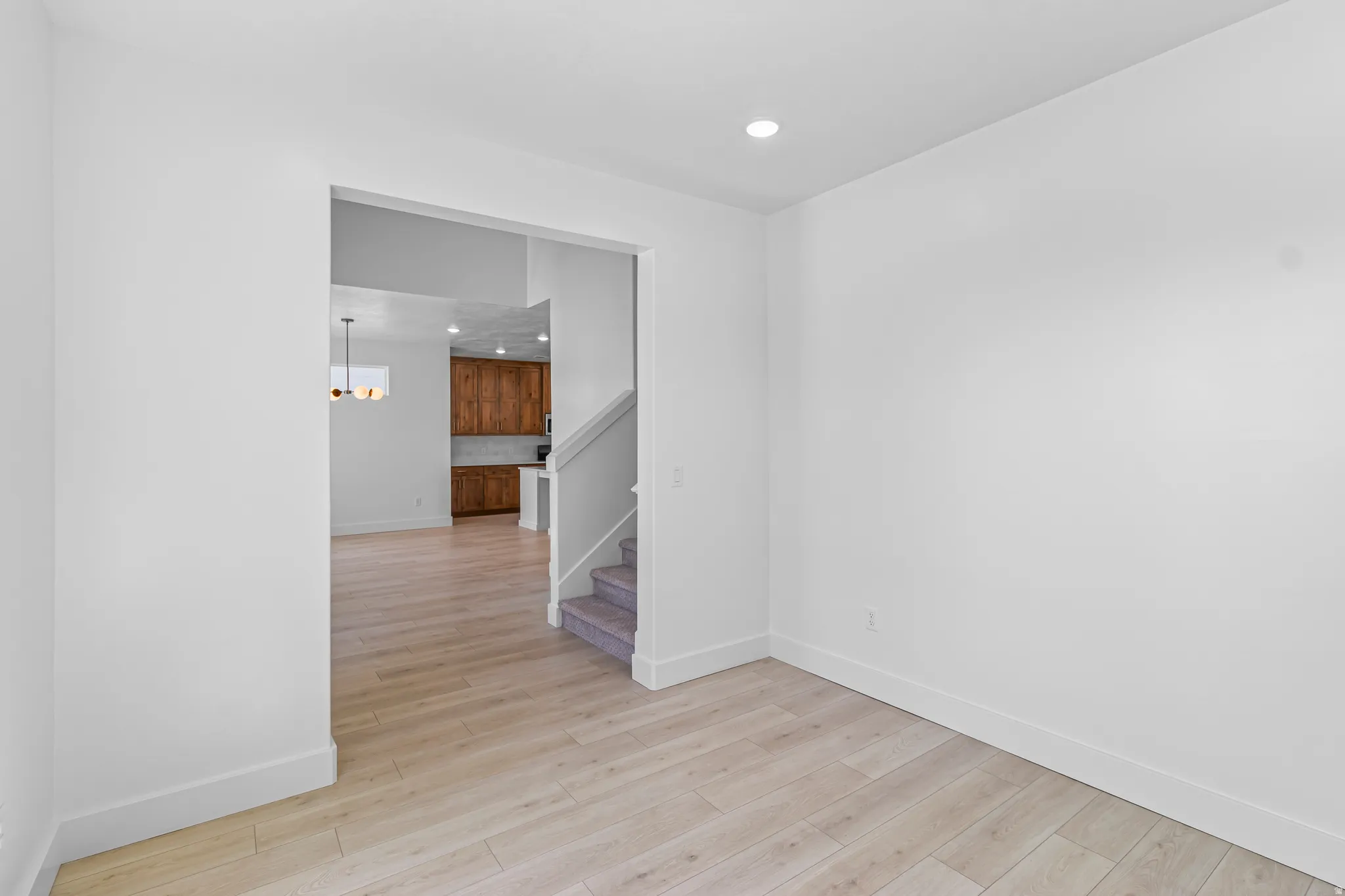 Room featuring light wood-finish flooring and white baseboards