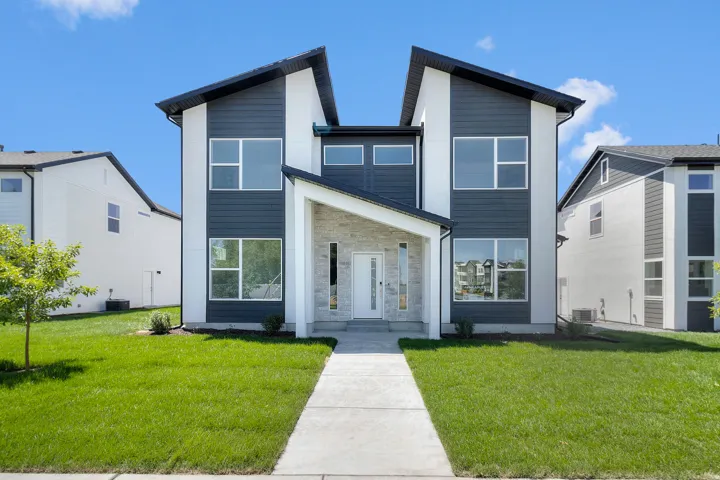 Contemporary exterior featuring dark horizontal siding and white stucco accents