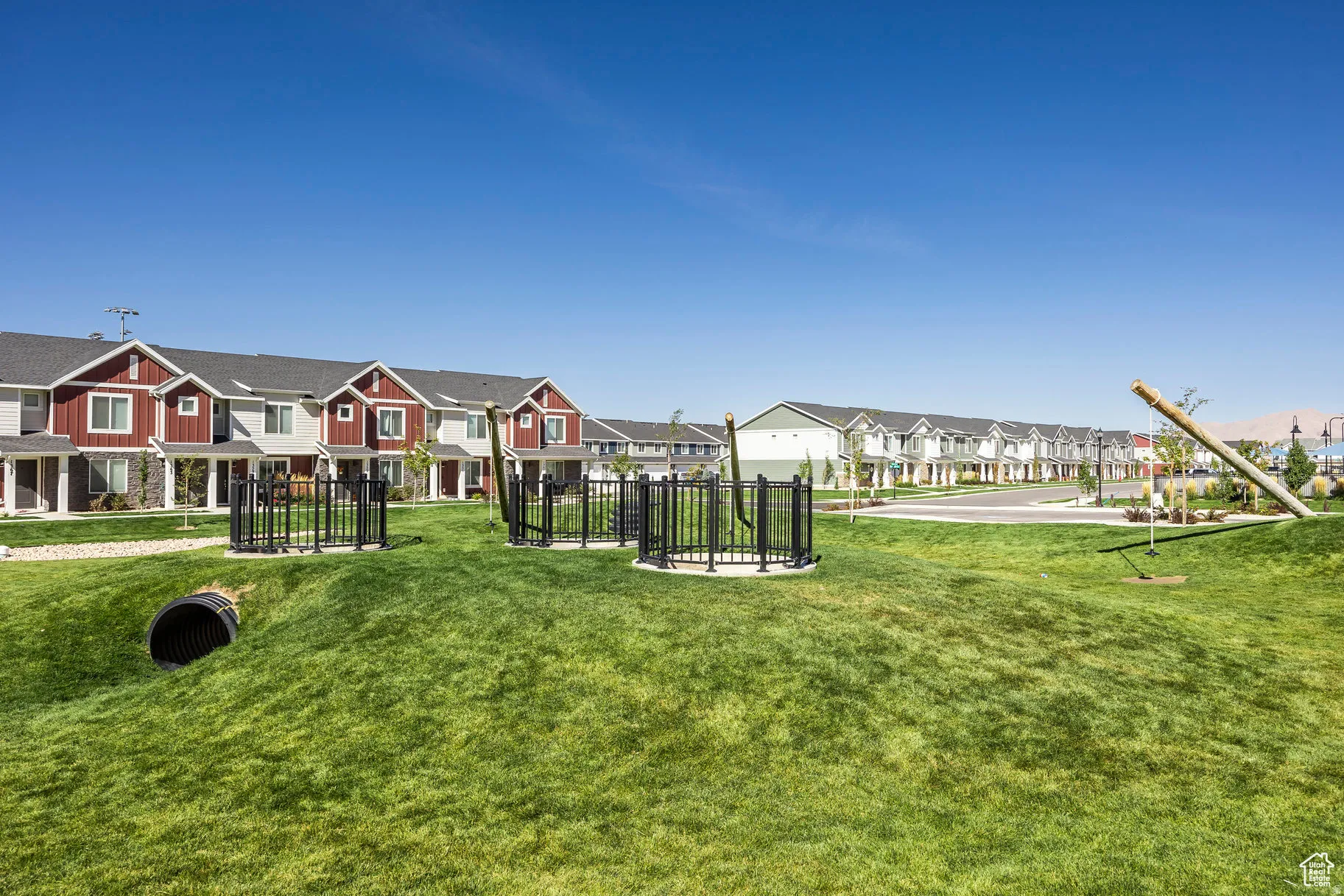 Expansive green space featuring rolling hills and integrated play structures