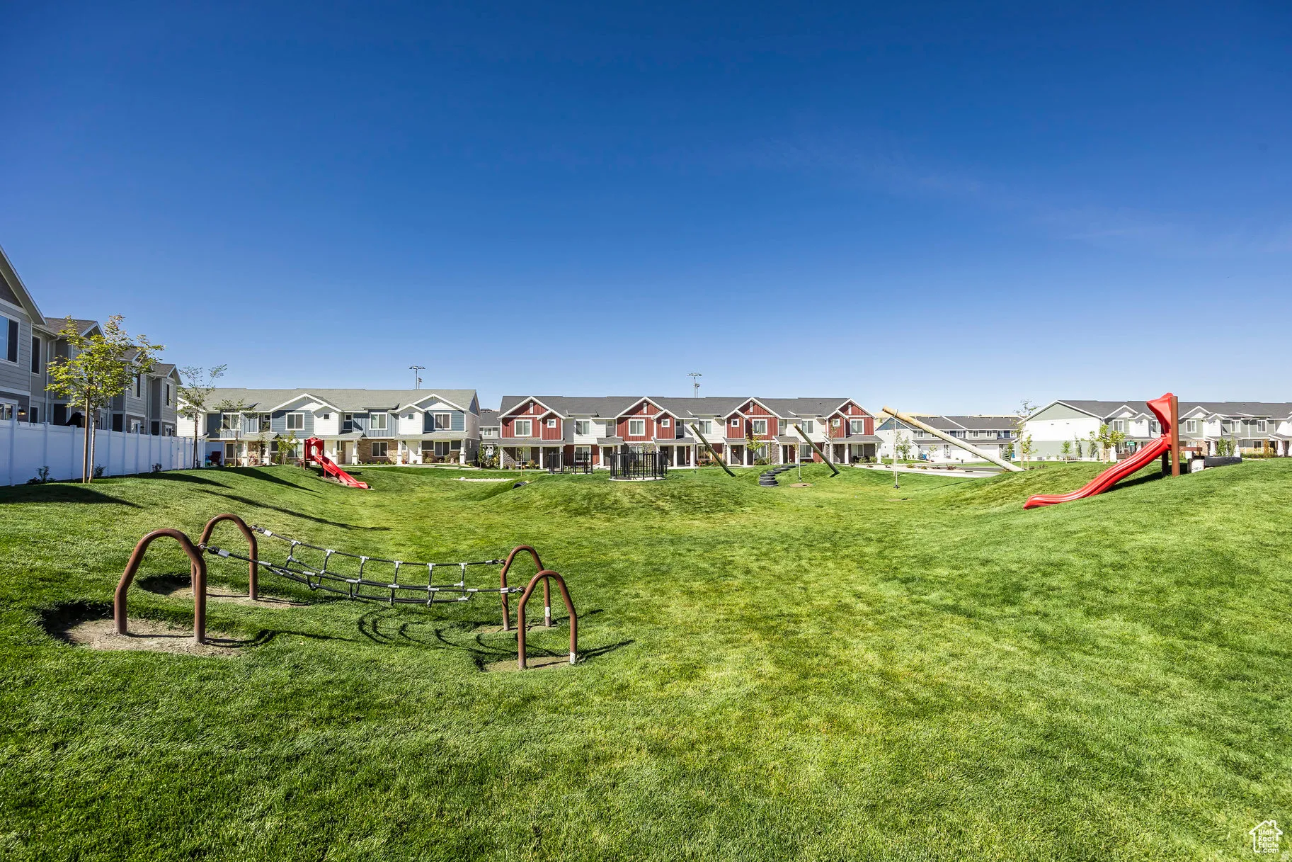 Expansive community green space featuring manicured lawns and varied terrain