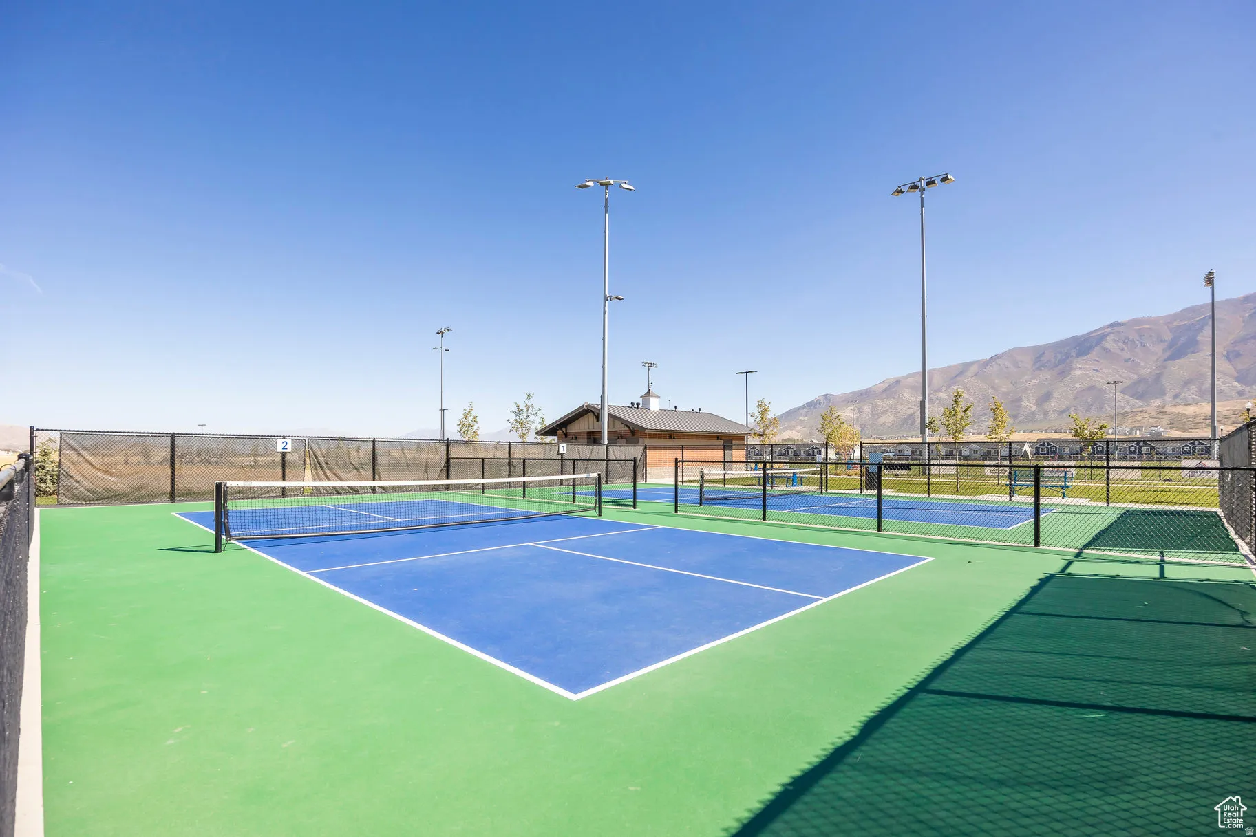 Multiple athletic courts featuring blue and green surfacing