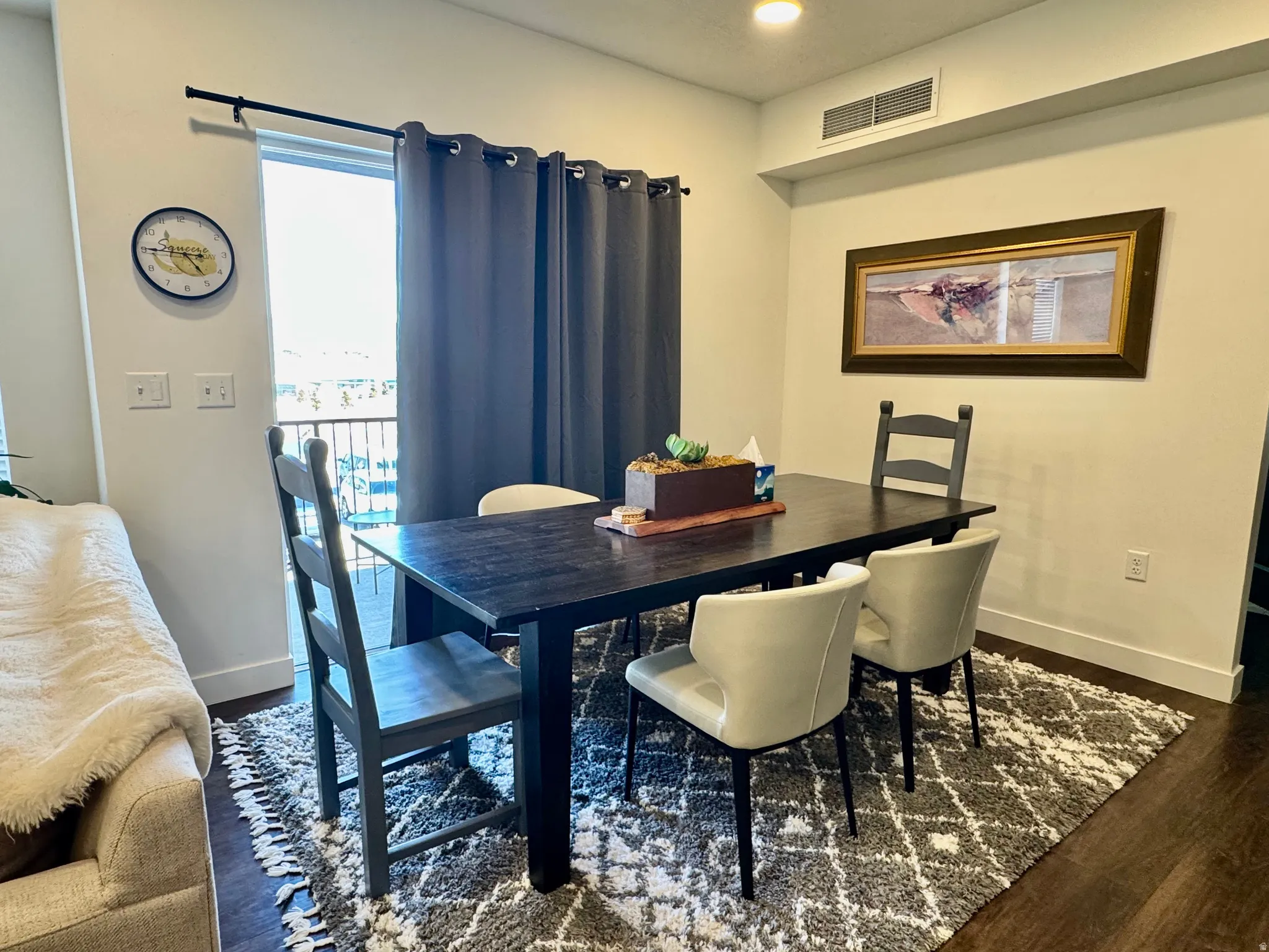 Dining area featuring wood-finish flooring and light neutral wall colors