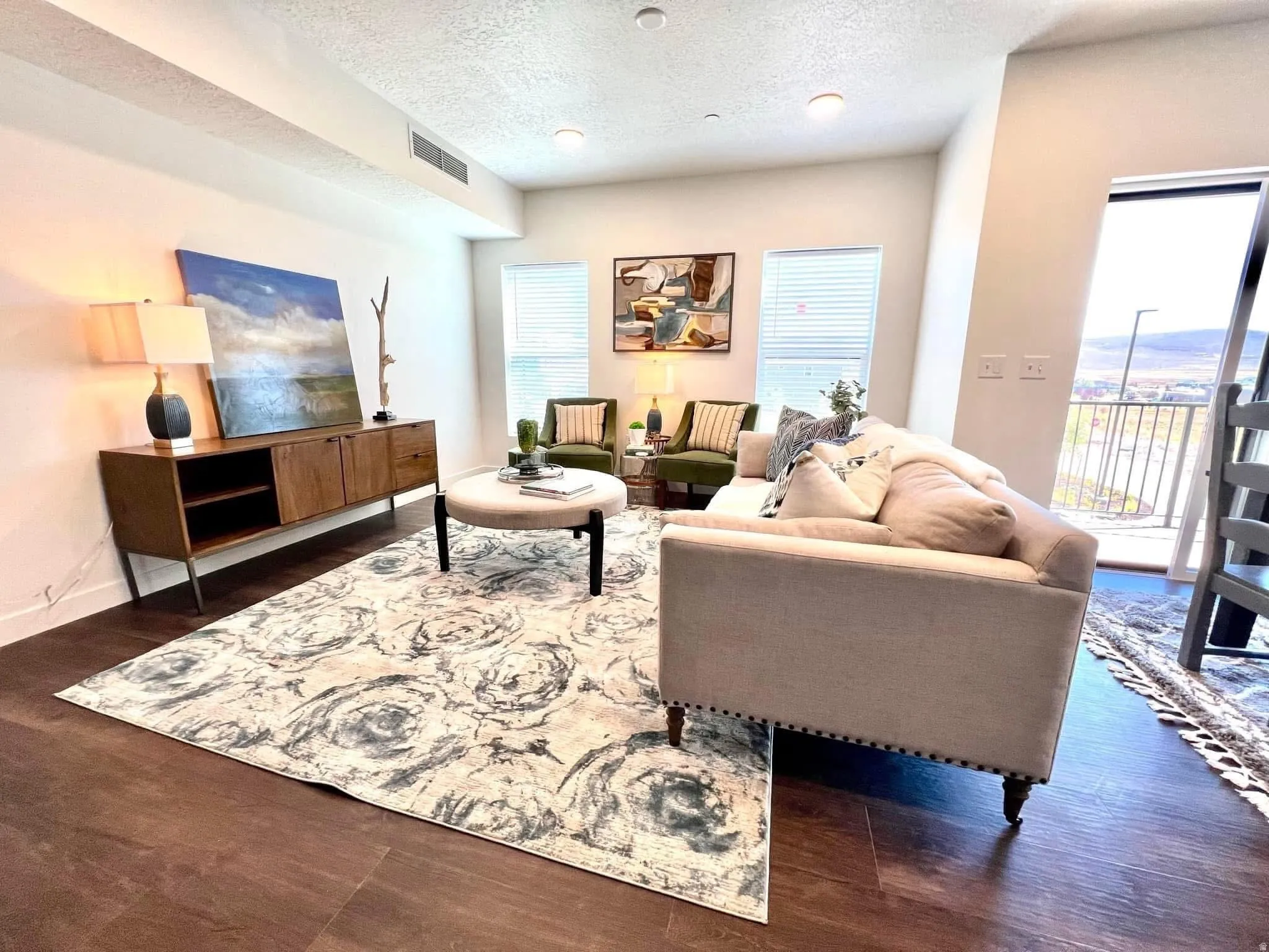 Open-concept living space featuring dark wood-finish flooring, recessed lighting, and high ceilings