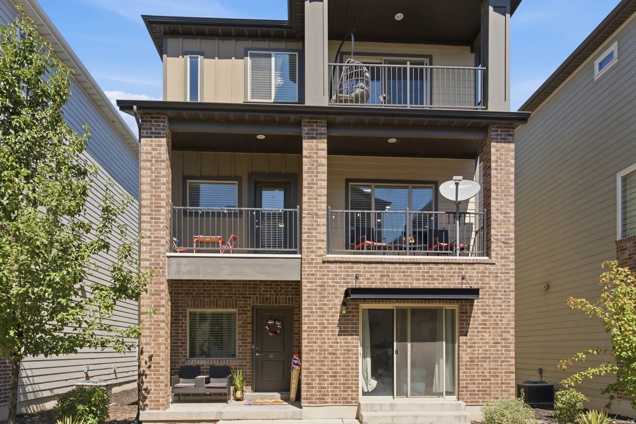 Three-story facade featuring brick and siding accents