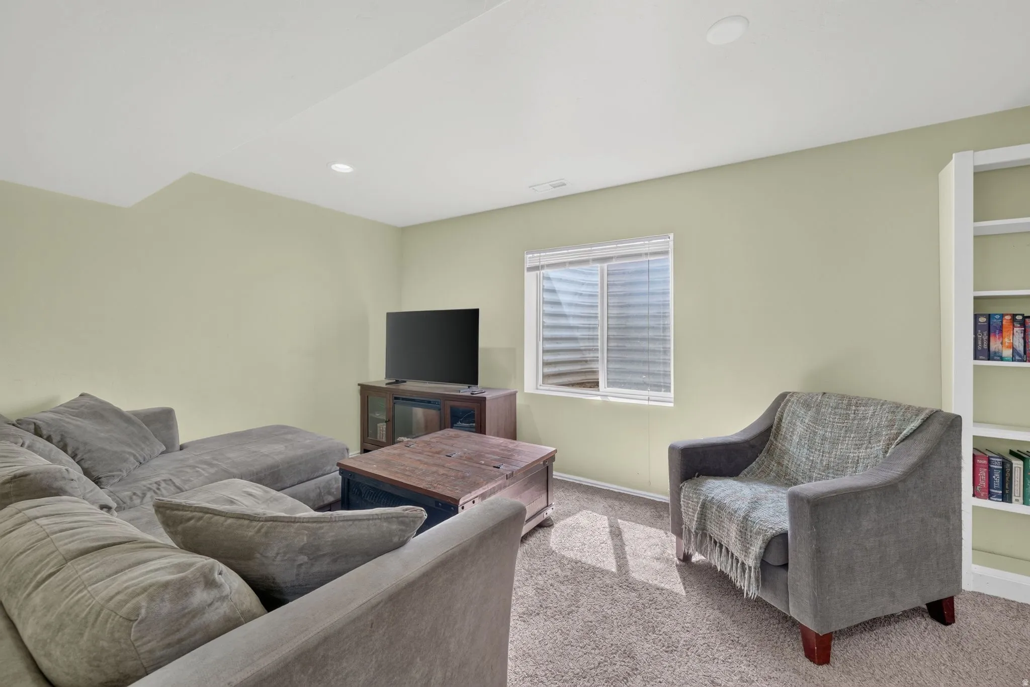Carpeted room featuring light-toned walls and recessed lighting