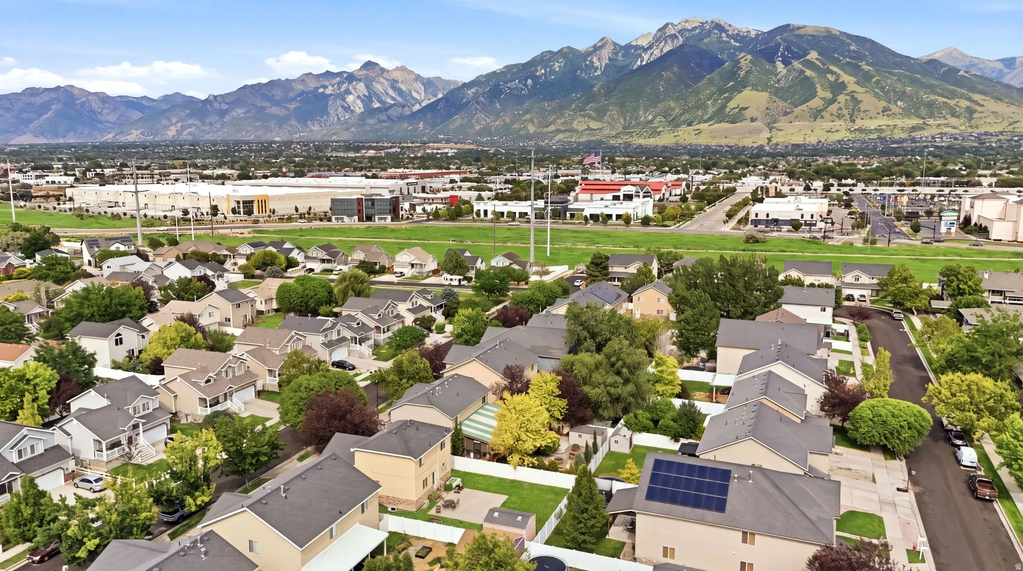 Aerial perspective showcasing a residential area with varied housing styles and mature landscaping