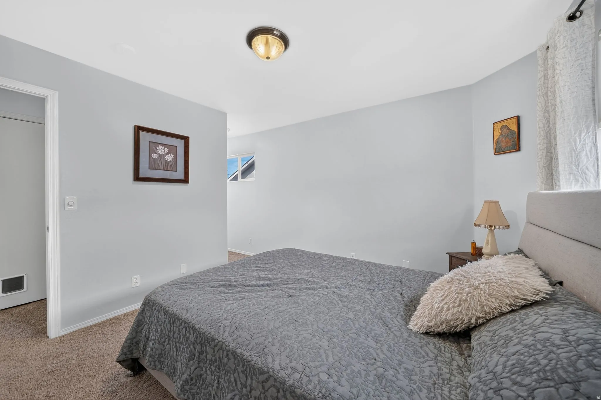 Carpeted bedroom with light blue walls and a white ceiling