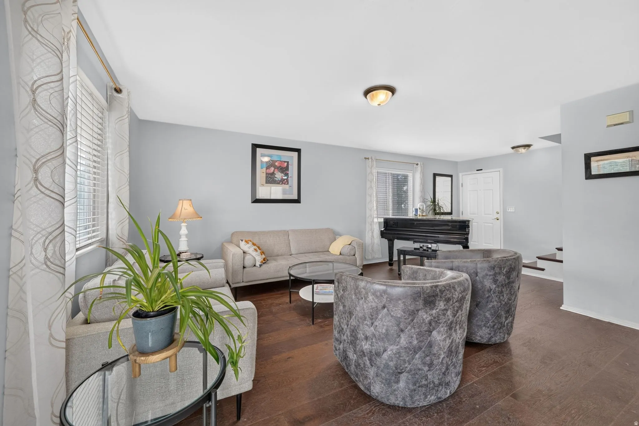 Living area featuring rich wood-finish flooring and light gray wall tones