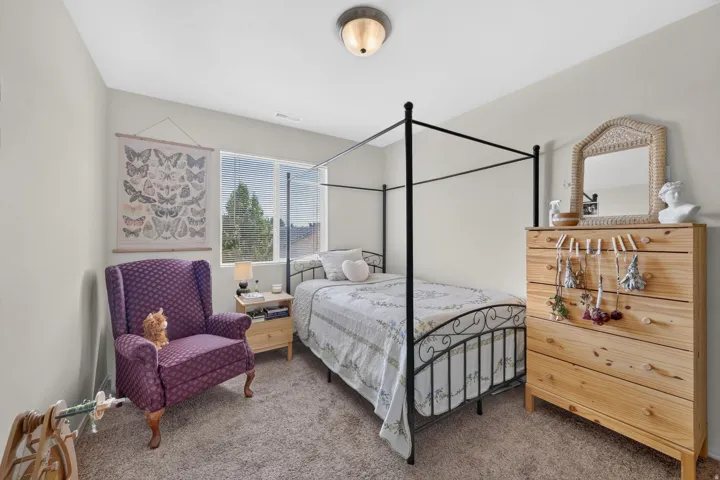 Carpeted room featuring a double window with horizontal blinds, light-toned walls, and a flush mount ceiling fixture