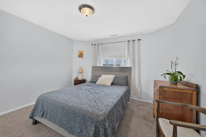 Carpeted bedroom featuring light blue walls and a white ceiling