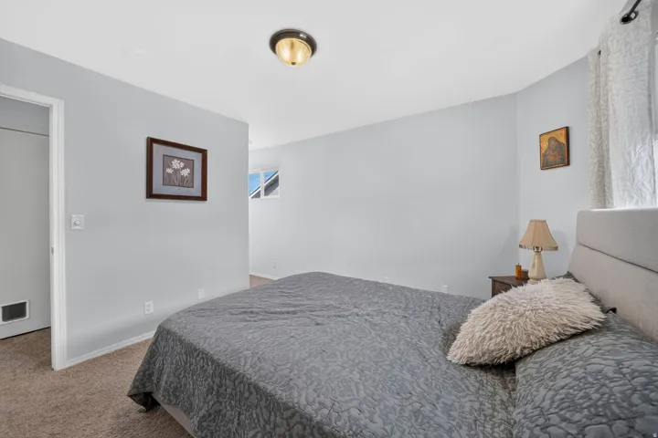 Carpeted bedroom with light blue walls and a white ceiling
