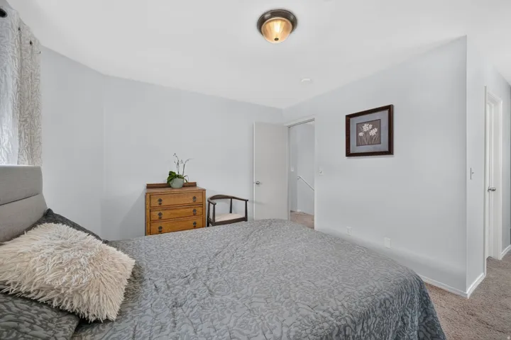 Neutral wall paint, ceiling-mounted light fixture, and carpet flooring
