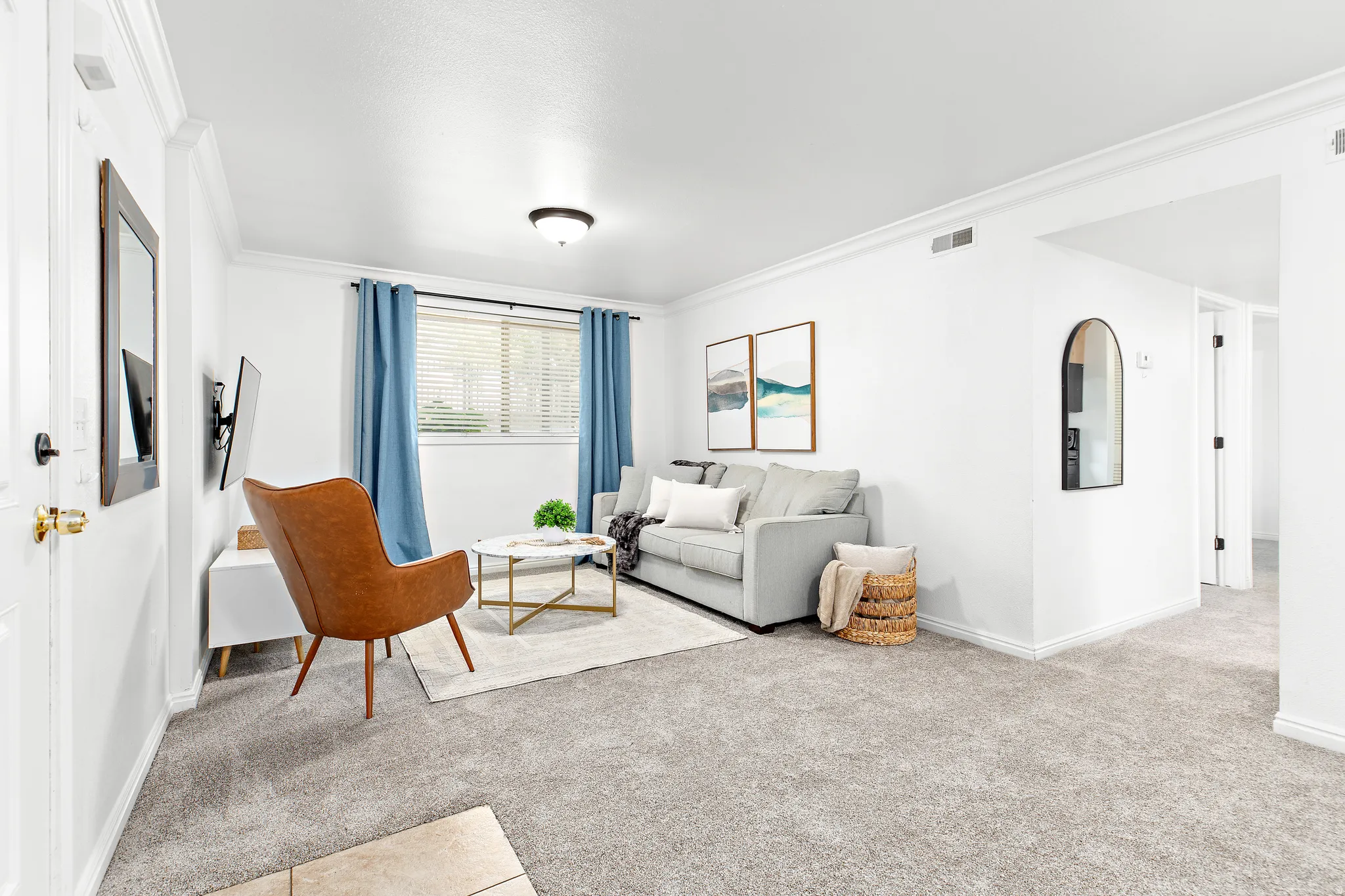 Living area featuring light gray carpeting and white walls