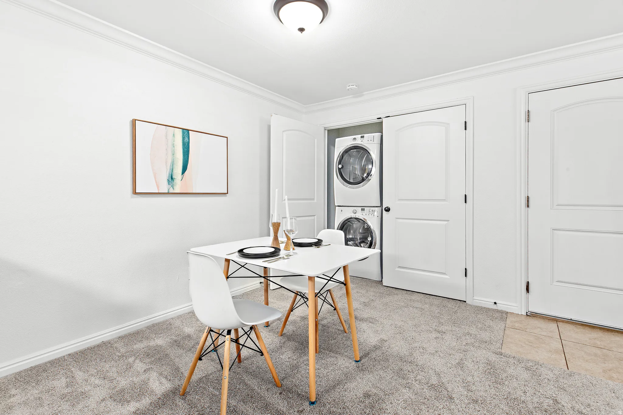 Dedicated laundry closet with stacked washer and dryer appliances