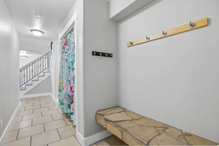 Entryway featuring flagstone-style built-in bench